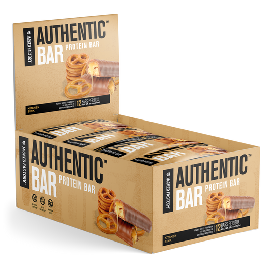 Jacked Factory's 12-pack of Kitchen Sink Authentic Bars in a beige box with pretzel and chocolate image